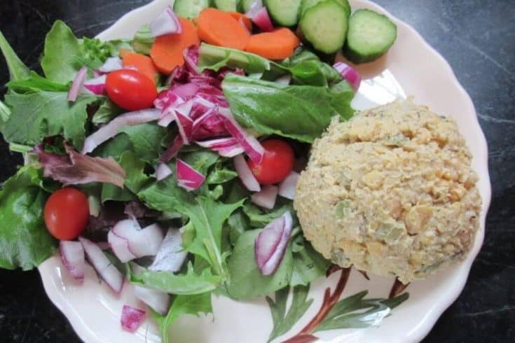 raw vegetables with a scoop of chickpea salad on a plate